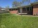 Charming front yard with a well-manicured lawn and a classic brick home, enhancing curb appeal at 8230 E 11Th St, Indianapolis, IN 46219
