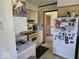 Functional kitchen featuring updated appliances, laminate countertops, and ample cabinet storage at 8230 E 11Th St, Indianapolis, IN 46219