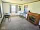 Bright living room features a decorative fireplace and ample natural light at 8230 E 11Th St, Indianapolis, IN 46219