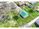 Expansive lot with green lawn, mature trees, and a large storage building with a green roof at 830 N 16Th St, Elwood, IN 46036