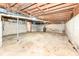 Spacious unfinished basement, ready for customization with exposed beams and ductwork at 830 N 16Th St, Elwood, IN 46036