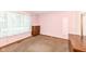 Bedroom with carpet flooring and a large window letting in natural light at 830 N 16Th St, Elwood, IN 46036