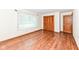 Bright bedroom featuring wood-look floors, natural light, and a closet at 830 N 16Th St, Elwood, IN 46036