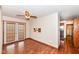 Bright dining area with wood laminate flooring and a ceiling fan, adjacent to the kitchen at 830 N 16Th St, Elwood, IN 46036