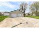 Two-car detached garage with an adjacent concrete driveway and a well-manicured lawn at 830 N 16Th St, Elwood, IN 46036