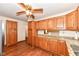 Well-lit kitchen featuring wooden cabinets, granite countertops and wood-look floors at 830 N 16Th St, Elwood, IN 46036