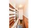 Bright storage space with wooden shelves and staircase leading to the basement at 830 N 16Th St, Elwood, IN 46036