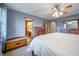 This bedroom features a ceiling fan, dresser and ensuite bathroom access at 838 Deerfield Rd, Anderson, IN 46012