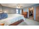 Comfortable bedroom featuring neutral carpet and a ceiling fan, plus a spacious walk-in closet at 838 Deerfield Rd, Anderson, IN 46012