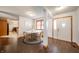 Bright dining area with wood floors, white walls, seating for four, and entry way into the home at 838 Deerfield Rd, Anderson, IN 46012