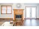 A cozy fireplace with natural light and wood trim is ready for a warm fire and an inviting glow at 838 Deerfield Rd, Anderson, IN 46012