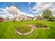 Beautifully landscaped front yard with a lush lawn, decorative bushes, and a well-maintained one-story home at 838 Deerfield Rd, Anderson, IN 46012