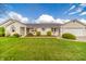 Charming one-story home with a manicured lawn and beautiful landscaping, showcasing curb appeal at 838 Deerfield Rd, Anderson, IN 46012