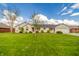 Beautiful one-story house featuring lush green lawn, mature trees, and well-maintained landscaping at 838 Deerfield Rd, Anderson, IN 46012