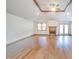 Open living room with wooden floors, ceiling fan, vaulted ceilings, and fireplace at 838 Deerfield Rd, Anderson, IN 46012