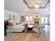 Spacious living room features vaulted ceilings, a fireplace, and plentiful seating, and wooden floors at 838 Deerfield Rd, Anderson, IN 46012