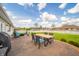 Backyard patio with comfortable seating, outdoor dining, and a well-manicured lawn at 838 Deerfield Rd, Anderson, IN 46012