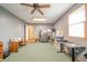 A spacious room with gray walls, a ceiling fan, and a desk for a functional workspace at 838 Deerfield Rd, Anderson, IN 46012