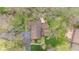 This aerial view of the property shows the dark roof, extensive yard, and mature tree coverage on the lot at 889 Cedar Wood Pl, Carmel, IN 46032