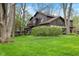 Spacious backyard featuring a deck, mature trees, and lush green lawn at 889 Cedar Wood Pl, Carmel, IN 46032