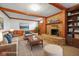 Cozy living room with stone fireplace and wood beams and soft seating at 889 Cedar Wood Pl, Carmel, IN 46032