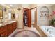 Well-appointed bathroom with dual vanities, soaking tub, and walk-in closet at 889 Cedar Wood Pl, Carmel, IN 46032