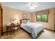 Inviting bedroom showcasing natural light, a study desk, and decor, creating a warm and functional area at 889 Cedar Wood Pl, Carmel, IN 46032