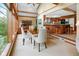 Bright dining area with large windows and a view of the landscaped backyard and adjacent kitchen at 889 Cedar Wood Pl, Carmel, IN 46032