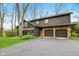 Home with stone accents, a two car garage and a paved driveway with mature landscaping at 889 Cedar Wood Pl, Carmel, IN 46032