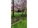 Landscaped front yard with mature trees and green grass create an inviting approach to this home at 889 Cedar Wood Pl, Carmel, IN 46032