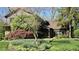 Beautiful home showcasing stone accents, mature landscaping, and a well-manicured lawn at 889 Cedar Wood Pl, Carmel, IN 46032
