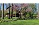 Charming home exterior featuring a lush green lawn, mature trees, and flowering bushes at 889 Cedar Wood Pl, Carmel, IN 46032