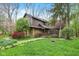Inviting home exterior with lush landscaping, mature trees, and a charming front porch at 889 Cedar Wood Pl, Carmel, IN 46032
