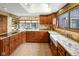 Spacious kitchen features granite countertops, custom wood cabinets, and a farmhouse sink at 889 Cedar Wood Pl, Carmel, IN 46032