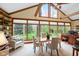Inviting sunroom with vaulted ceilings, large windows, and views of the backyard at 889 Cedar Wood Pl, Carmel, IN 46032