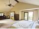 Main bedroom with vaulted ceiling, ceiling fan, and balcony access at 889 Cedar Wood Pl, Carmel, IN 46032
