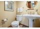 Cozy powder room with pedestal sink, decorative mirror, and neutral color scheme at 889 Cedar Wood Pl, Carmel, IN 46032