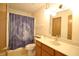 Bathroom with wooden cabinets, mirror, and moon-themed shower curtain at 8911 Country Walk Ct, Indianapolis, IN 46227