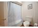 Bathroom with toilet and bathtub enclosed with shower curtain at 8911 Country Walk Ct, Indianapolis, IN 46227