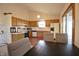 Well-lit kitchen featuring updated appliances, wood cabinets, and a breakfast bar at 8911 Country Walk Ct, Indianapolis, IN 46227