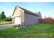 Home's side yard featuring vinyl siding, an attached garage and a small garden area with potted plants at 8911 Country Walk Ct, Indianapolis, IN 46227