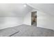 Finished attic space with neutral carpeting and white walls that could be used for storage at 911 W Washington Ave, Shelbyville, IN 46176