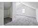 Finished attic space with neutral carpeting, dormer windows, and white walls, perfect for extra living area at 911 W Washington Ave, Shelbyville, IN 46176