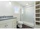 Bathroom featuring gray granite counters, white cabinets, and a glass-enclosed shower with white subway tile at 911 W Washington Ave, Shelbyville, IN 46176