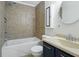 Cozy bathroom with bathtub and shower, and an elegant round mirror at 911 W Washington Ave, Shelbyville, IN 46176