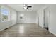 A bright bedroom with gray wood-look flooring and windows offering views of the surrounding neighborhood at 911 W Washington Ave, Shelbyville, IN 46176