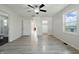 A bright bedroom with gray wood-look flooring and multiple doorways, including one to a bathroom at 911 W Washington Ave, Shelbyville, IN 46176