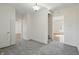 Carpeted hallway with neutral paint offers multiple routes into adjoining rooms at 911 W Washington Ave, Shelbyville, IN 46176