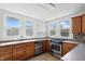 Well-lit kitchen featuring granite counters, stainless steel appliances and tile flooring at 911 W Washington Ave, Shelbyville, IN 46176