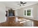 Sunlit living room boasts hardwood floors, a bay window, and a cozy fireplace at 911 W Washington Ave, Shelbyville, IN 46176